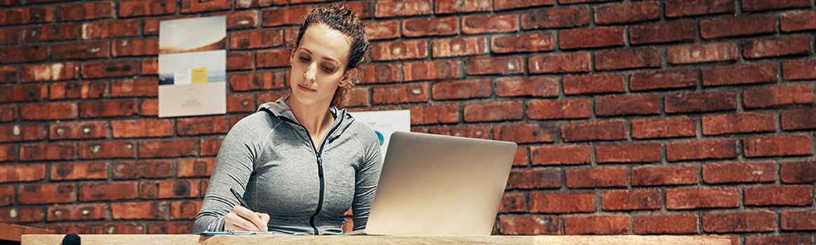 Woman sitting at her laptop completing an online training course